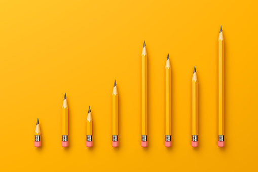 2B pencils forming a bar graph on yellow background. Horizontal composition with copy space.