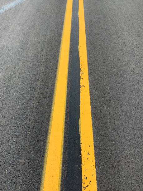 istock Double Yellow Line on Asphalt Street 1160401139