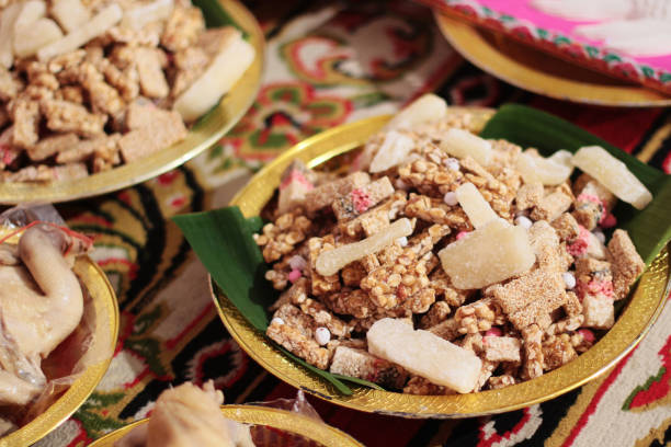 Thai Sweet Cereal Bar made of rice, nut, sesame-seeds and sugar on gold tray  for Thai engagement ceremony.