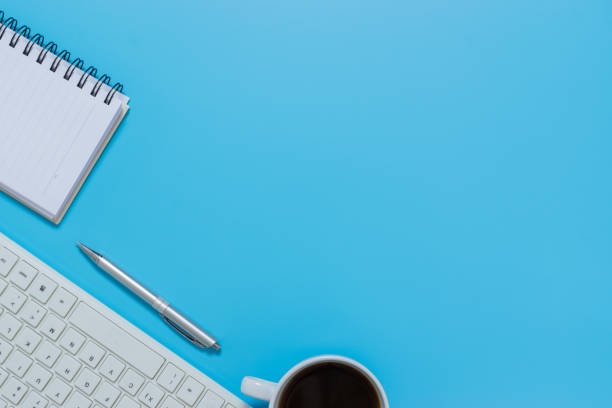istock Top view keyboard,notebook,pen, or object for office supply concept on blue background. 1160401941