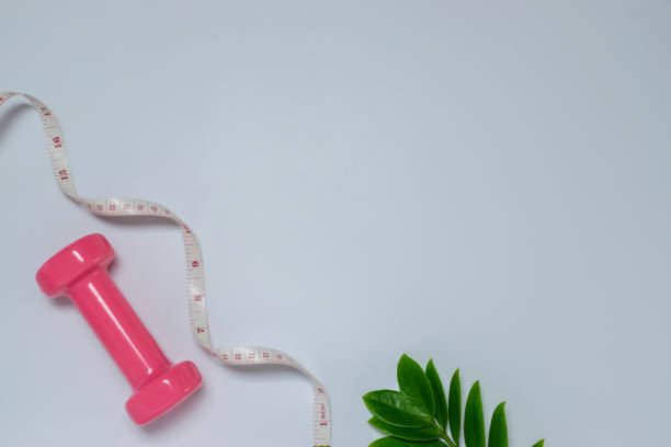istock Healthy object on table with dumbbells,green leaves,measuring for sport or exercise concept on blue background. 1160402022