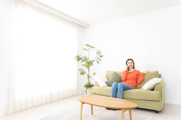 istock Young woman calling on phone at home 1160402260