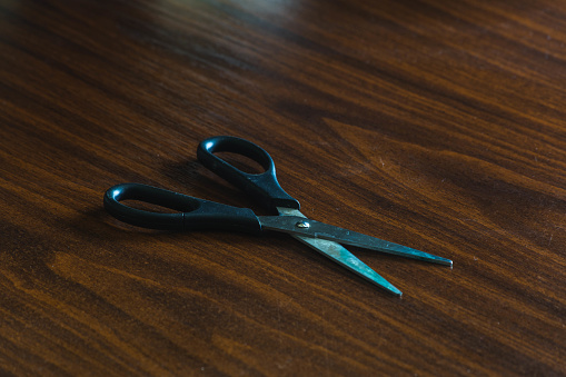 scissors with a black handle on the table