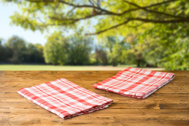 istock Empty wooden table with tablecloth over autumn nature park background 1160405052