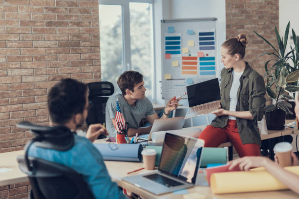 istock Young colleagues discussing their business ideas in office 1160405119