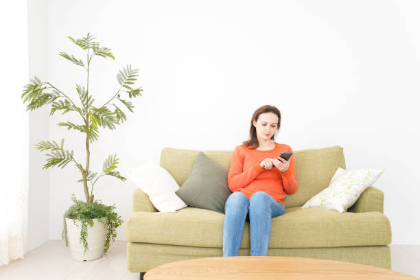 istock Young women using a smartphone at home 1160406141