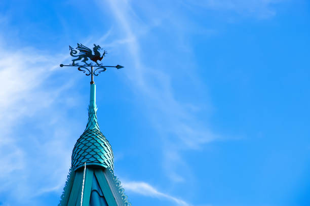 istock The dome with a steeple decorated with a dragon. Against the sky with clouds. 1160406418