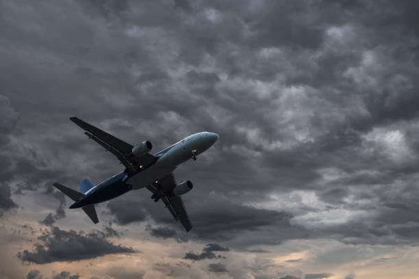 istock Airplane with dramatic sky, flying at bad weather with dark clouds 1160406776