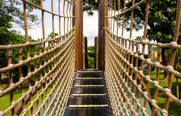 istock wooden bridge with strong robe at playground perspective 1160410154