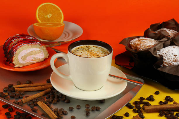 istock Cup of coffee with muffins, rolls and orange 1160410479