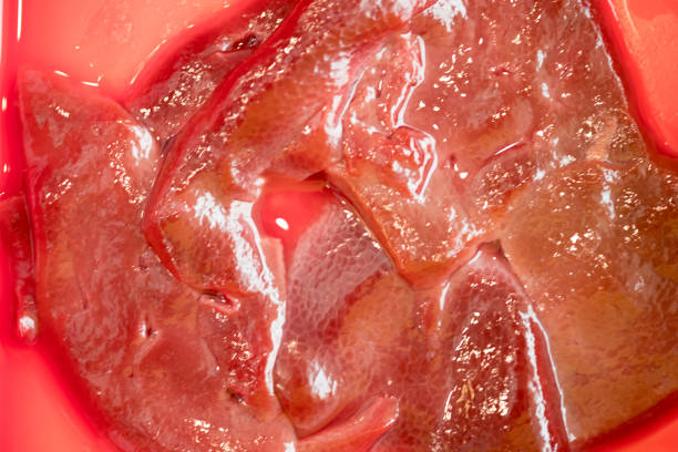 Raw fresh sliced pork liver on red tray ready to cook