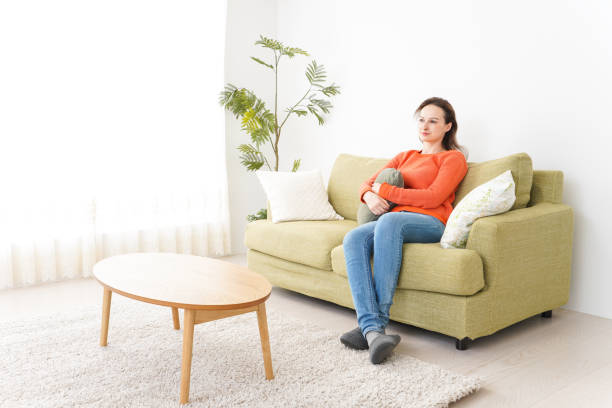 istock Young woman watching TV at home 1160413326