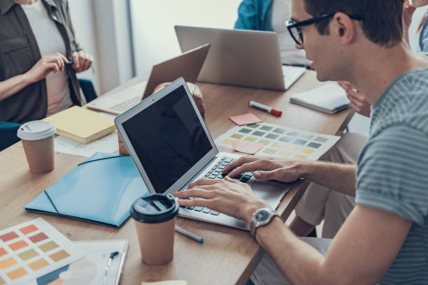 istock Young guy concentrated on his working tasks in office 1160413627