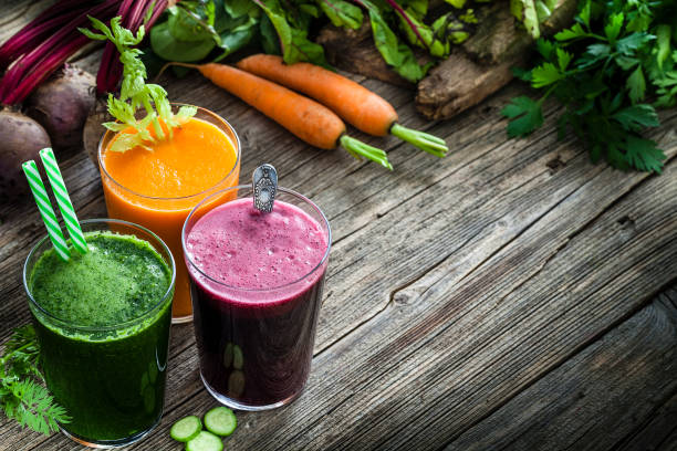 istock Vegetable drinks: beet, carrot and green vegetables juices on rustic wooden table. Copy space available 1160415688