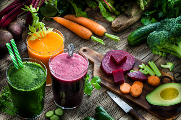 istock Vegetable drinks: beet, carrot and green vegetables juices on rustic wooden table 1160415689