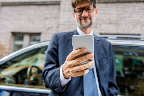 istock businessman using his smartphone in the city 1160416469