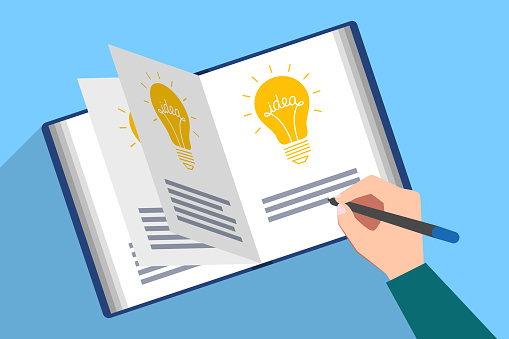 Book filled with picture of light bulb and the text of idea. Hand with pen are writing description of new genial idea. Generator of ideas, creative person, author creativity