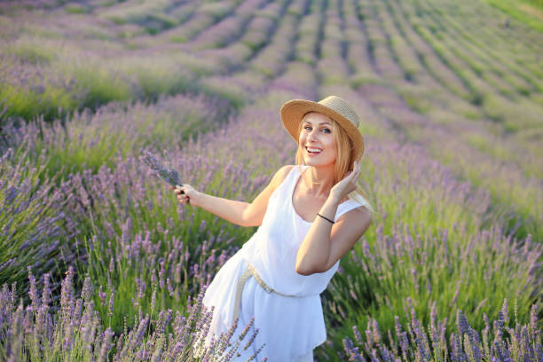 istock Young beautiful woman in a lavender field 1160418628