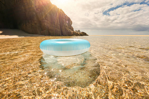 istock Pale blue rubber ring floating on shallow clear sea at Pedn Vounder Beach, Cornwall on an idyllic sunny june day. 1160420775