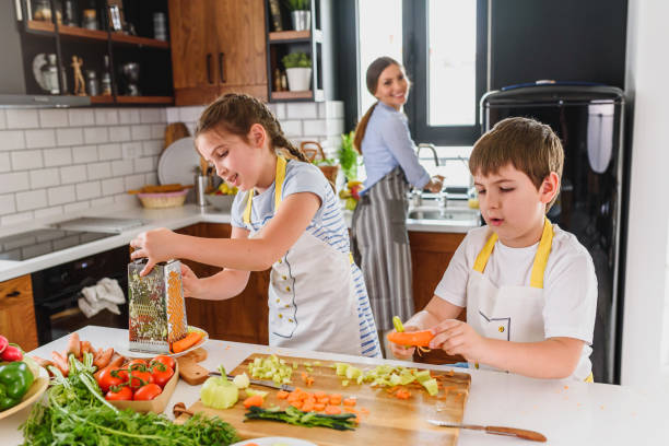 istock Mother Teaching Kids to Cook and Help in the Kitchen 1160422285