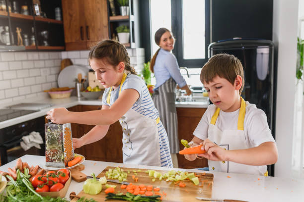 istock Mother Teaching Kids to Cook and Help in the Kitchen 1160422294