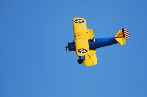 Shot of a yellow Crop duster spraying the Canola fields near Tulbagh in the Western Cape