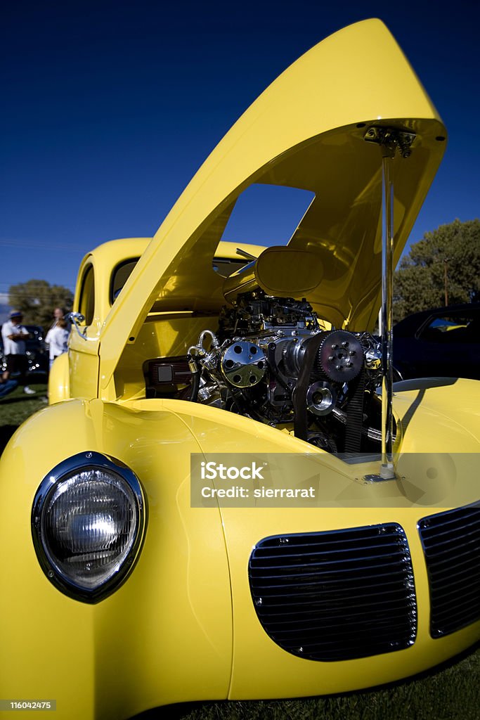 Antique Hot Rod Yellow 1940 Ford with chrome grille. Sharp focus is on the engine. Drag Racing Stock Photo