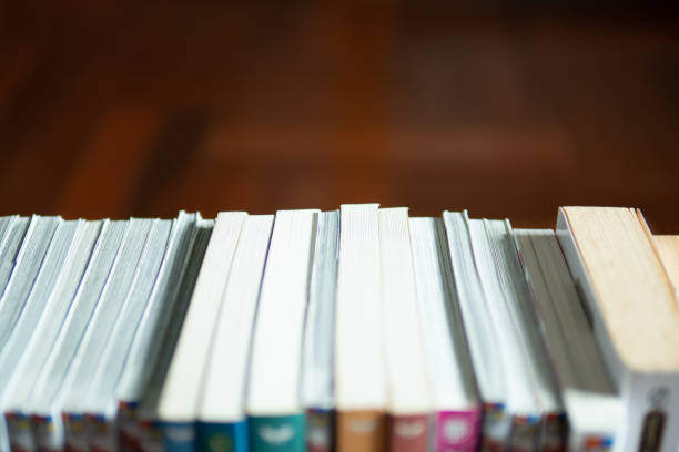istock pile of books on wooden table 1160425129