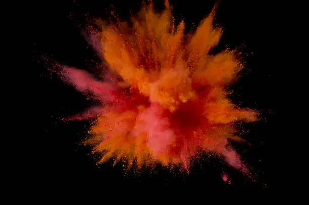 Photo of Colored powder explosion. Abstract closeup dust on backdrop. Colorful explode. Paint holi