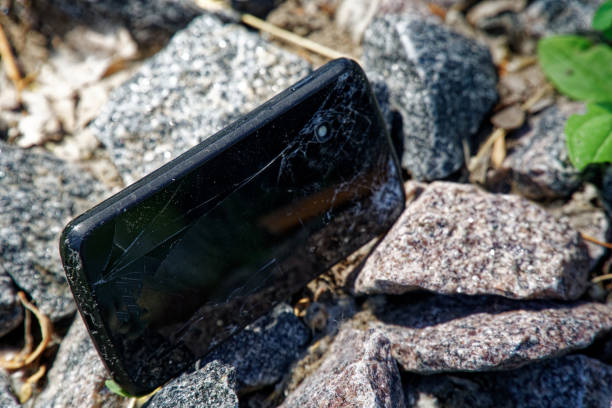 istock Broken cellphone abandoned and lost among the gravel 1160426250