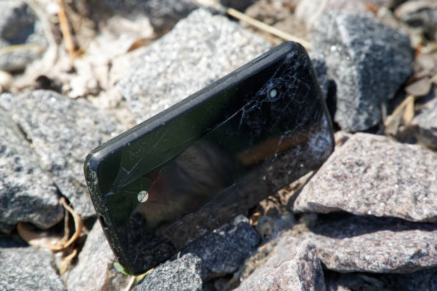 istock Broken cellphone abandoned and lost among the gravel 1160426458