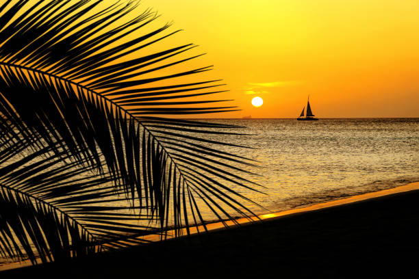 istock orange colored shiny seascape with sailboat over sunset sky 1160430002