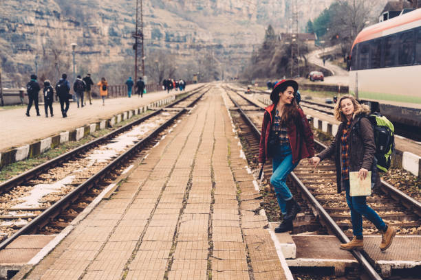 a man walking on rails, a view of feet walking on railroad tracks. High quality photo