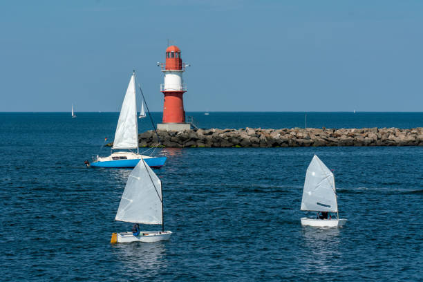 east pier with red beacon and little white sailingboats in Warnemuende