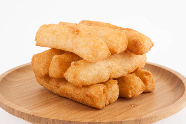 tasty fried yucca sticks on white background.