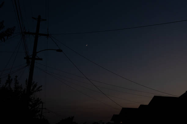 istock Telephone Pole and wires with Crescent Moon 1160440457