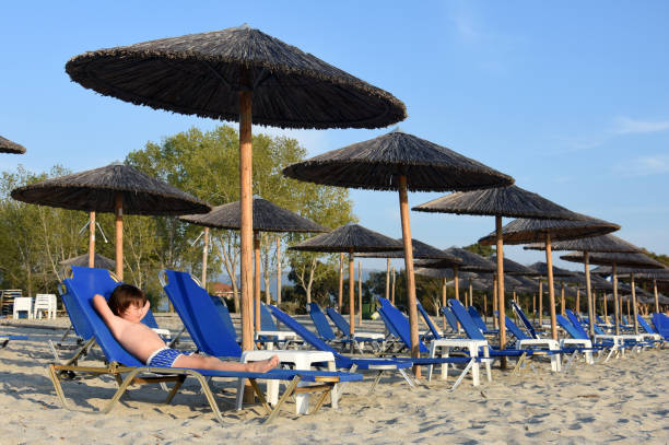 istock Little boy enjoy  in deck chairs on the beach during vacations 1160443219