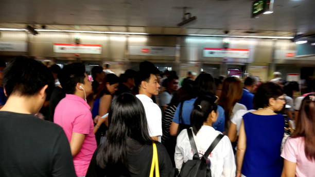 Crowd in MRT Singapore Singapore, Singapore-June 1, 2019: Commuters in MRT Subway Singapore. singapore mrt stock pictures, royalty-free photos & images