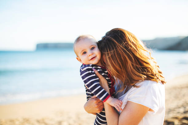 istock Mother with her little son at the beach 1160445379