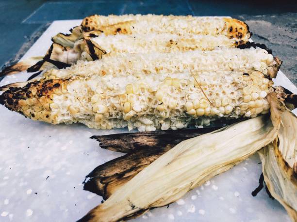 Quickly Eaten Fresh Ears of Organic Grilled White Corn Summer treat of grilled ears of organic white corn. Quickly eaten but still photo worthy. corn cob eaten stock pictures, royalty-free photos & images