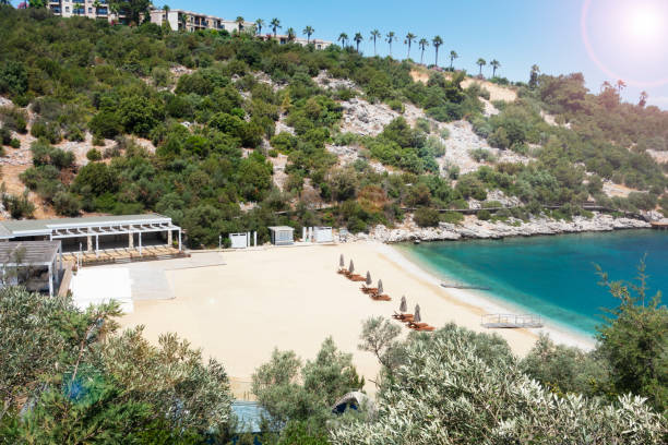 istock Beach chairs with umbrellas and beautiful sand beach 1160447534