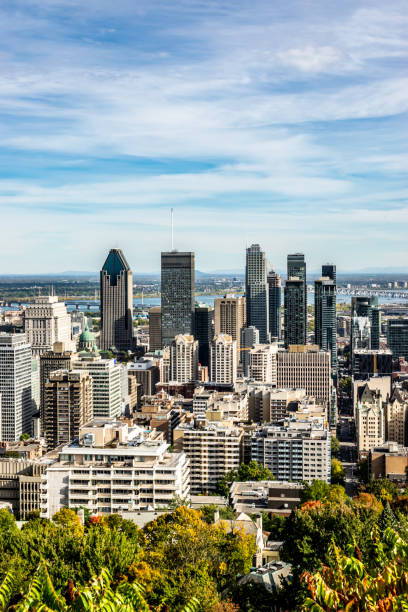 Montreal city view from the Mount Royal during fall with its high rise buildings under blue skies.