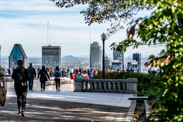 People looking at Montreal cityscape in autumn.
