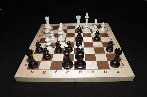 Chechered board under white pieces as a strategy backdrop