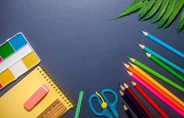 istock School supplies on dark blue background. Back to school concept 1160451455