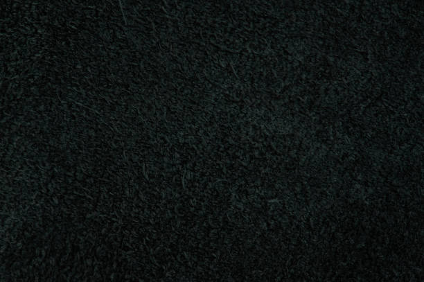 Black fleece fur texture background close up view
