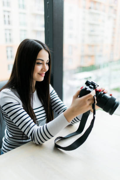 istock Freelance photographer woman with camera in hands 1160461752