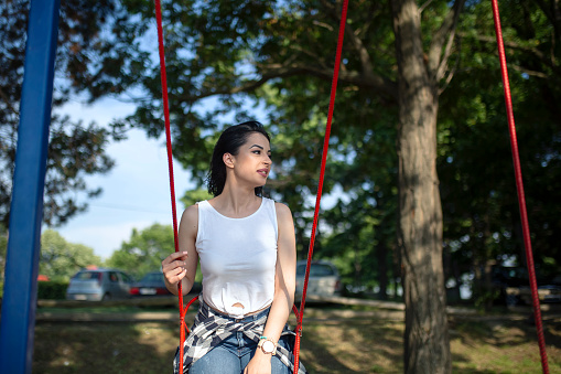 Young women sitting on a swing