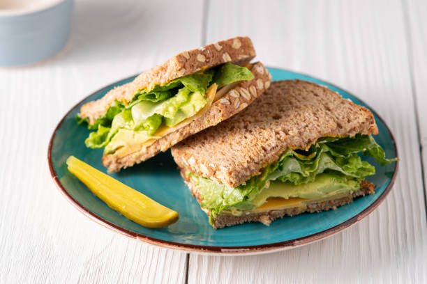 istock Avocado cheese and lettuce sandwich with pickle side 1160466600
