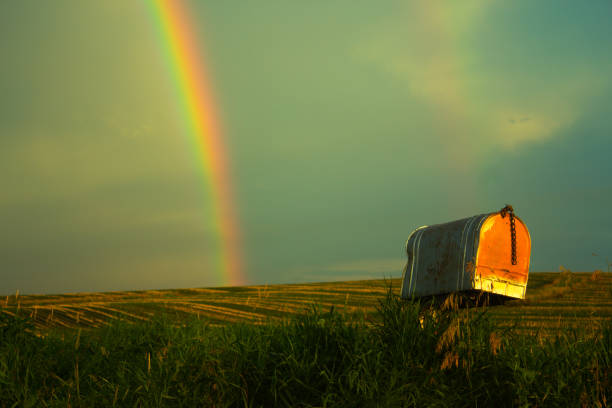 istock Rusty mailbox with rainbow and cornfield against a vintage sky 1160469027